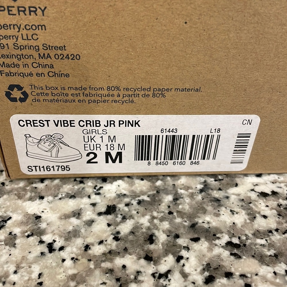 Brand new, never worn infant Sperry crib shoe in a soft pink.